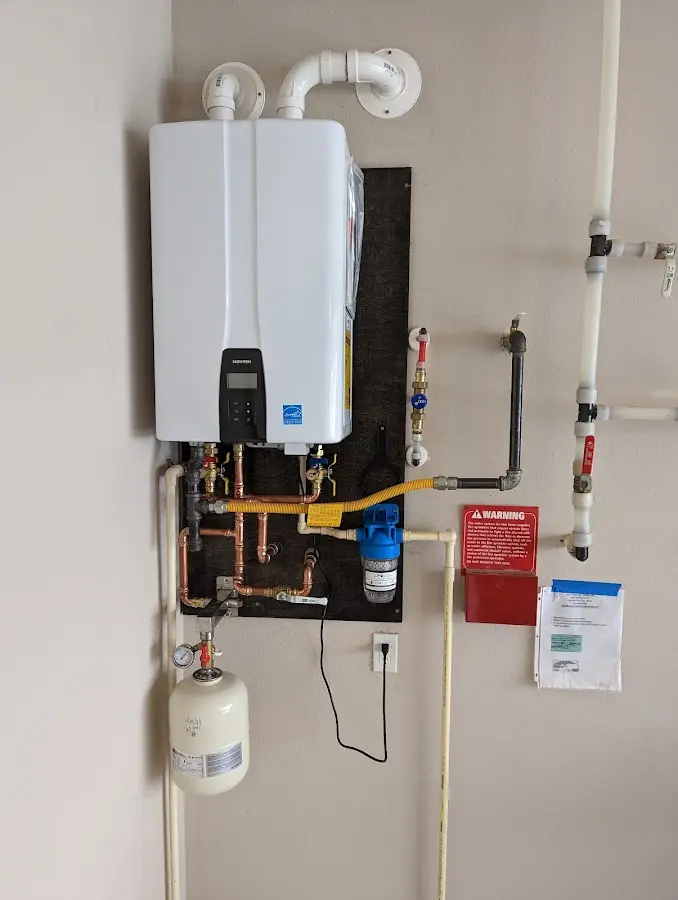 Professional plumber installing copper piping in a Greenfield home